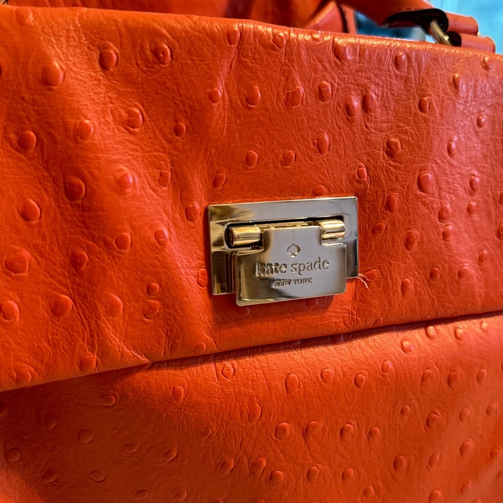 Orange Kate Spade spring / summer handbag with ostrich leather stamping.
